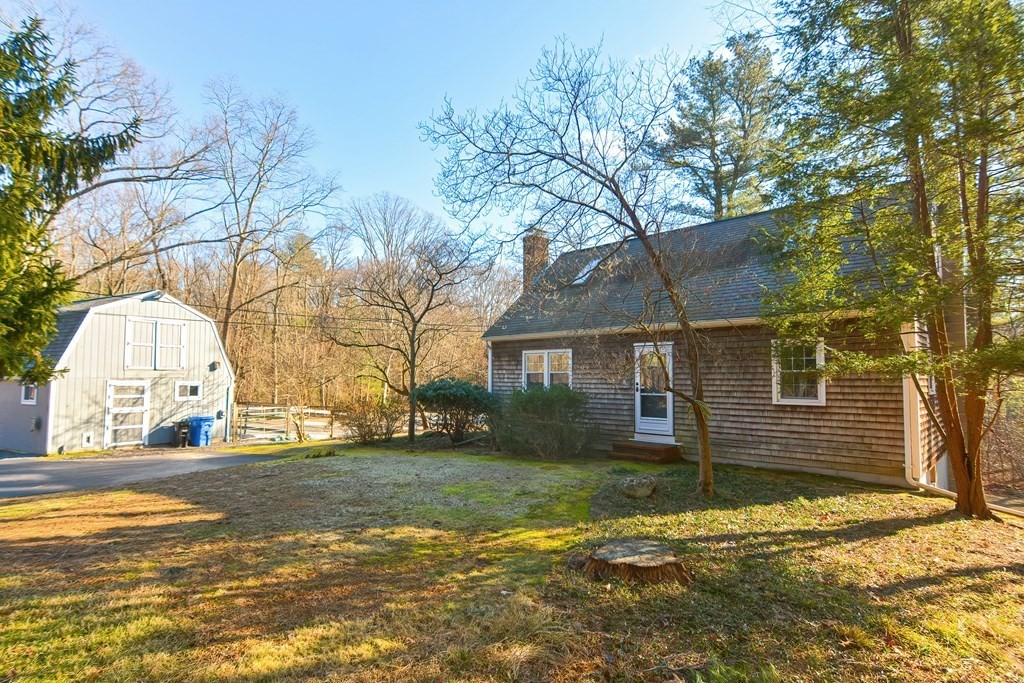 325 Spring Street Wrentham, MA 02093 - Photo 16 of 42 a front view of a house with a yard and garage