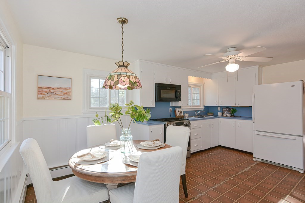 325 Spring Street Wrentham, MA 02093 - Photo 18 of 42 a kitchen with a dining table and chairs