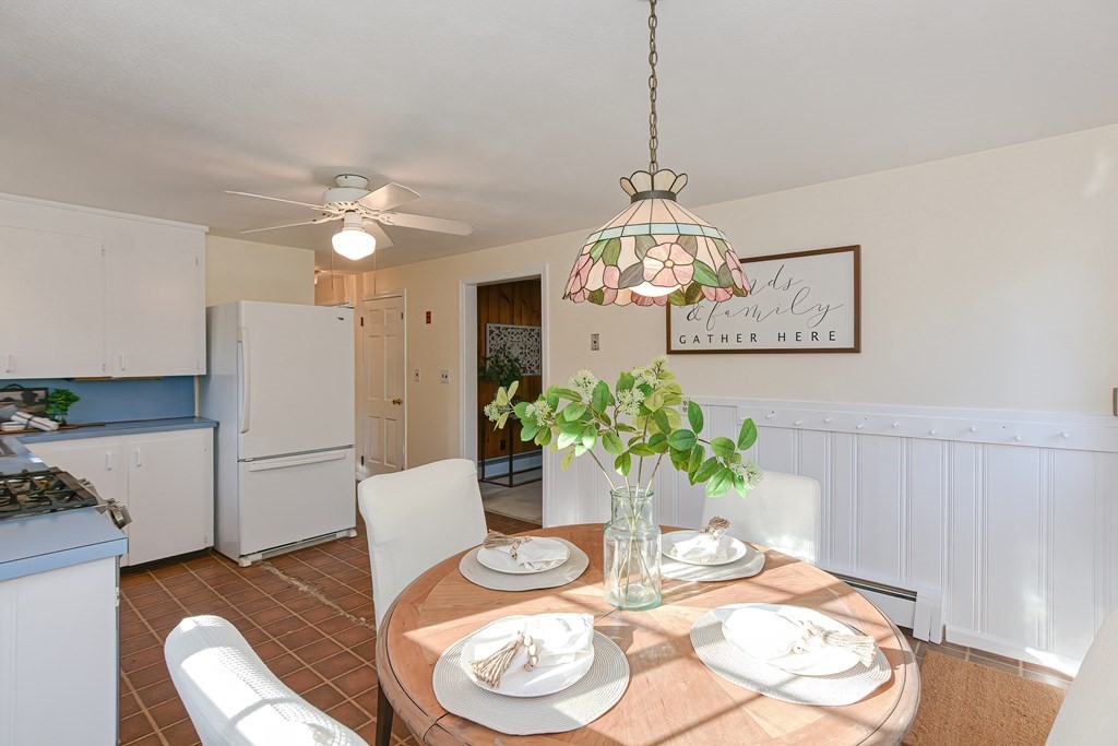 325 Spring Street Wrentham, MA 02093 - Photo 21 of 42 a dining room with furniture and a chandelier
