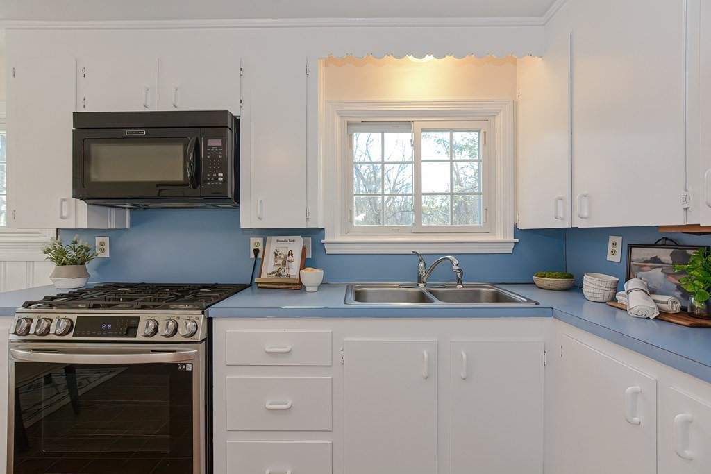 325 Spring Street Wrentham, MA 02093 - Photo 23 of 42 a kitchen with stainless steel appliances granite countertop a sink stove top oven and microwave