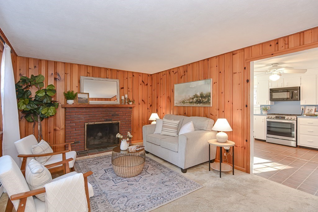 325 Spring Street Wrentham, MA 02093 - Photo 24 of 42 a living room with furniture and a fireplace