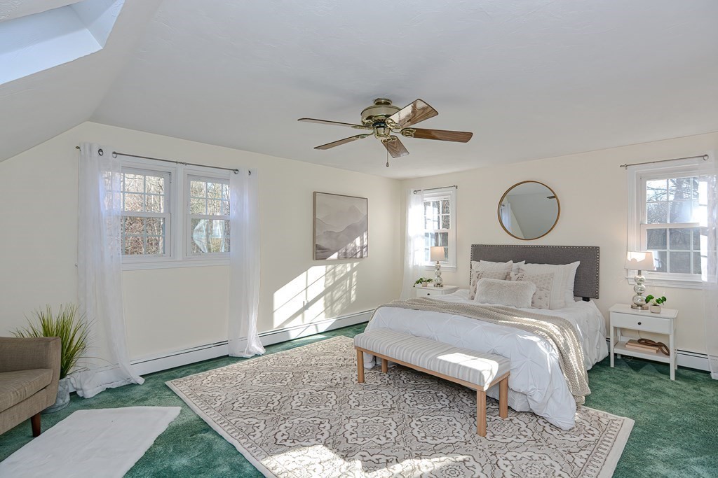325 Spring Street Wrentham, MA 02093 - Photo 34 of 42 a bed room with a bed and a chandelier