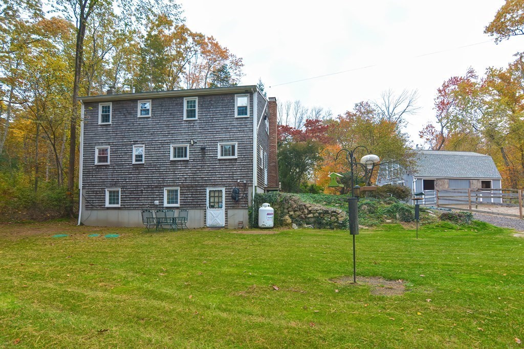 325 Spring Street Wrentham, MA 02093 - Photo 5 of 42 a brick house with a yard in front of it