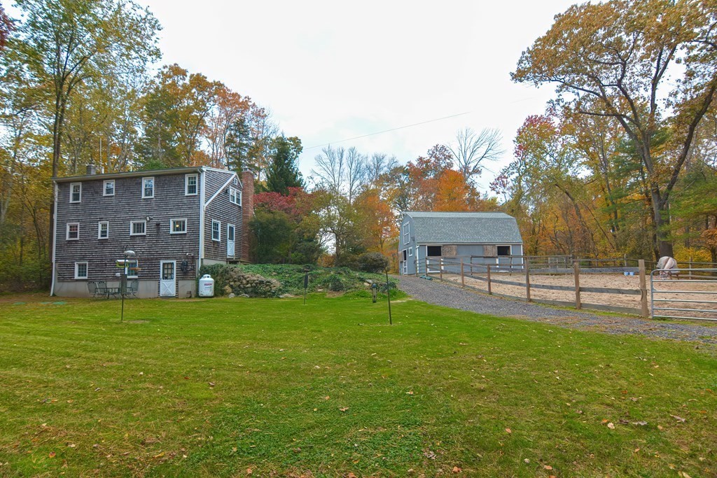 325 Spring Street Wrentham, MA 02093 - Photo 7 of 42 a view of a house with a big yard and a large tree