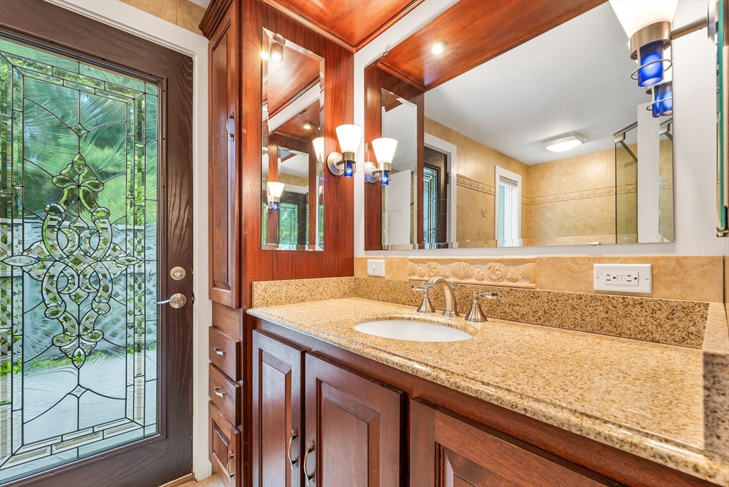 3 Burning Bush Drive Boxford, MA 01921 - Photo 32 of 42 a bathroom with a granite countertop sink and large mirror