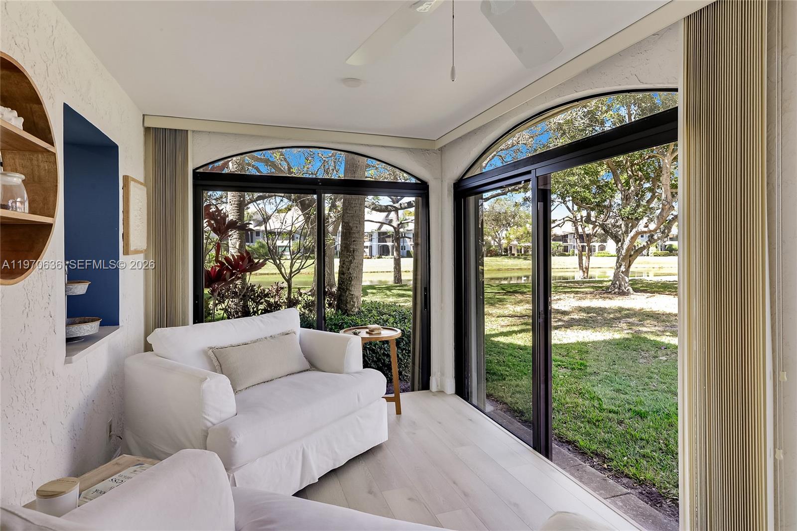 16671 Traders Crossing North, Unit 121 Jupiter, FL 33477 - Photo 7 of 14 Light filled Florida Room with lake view