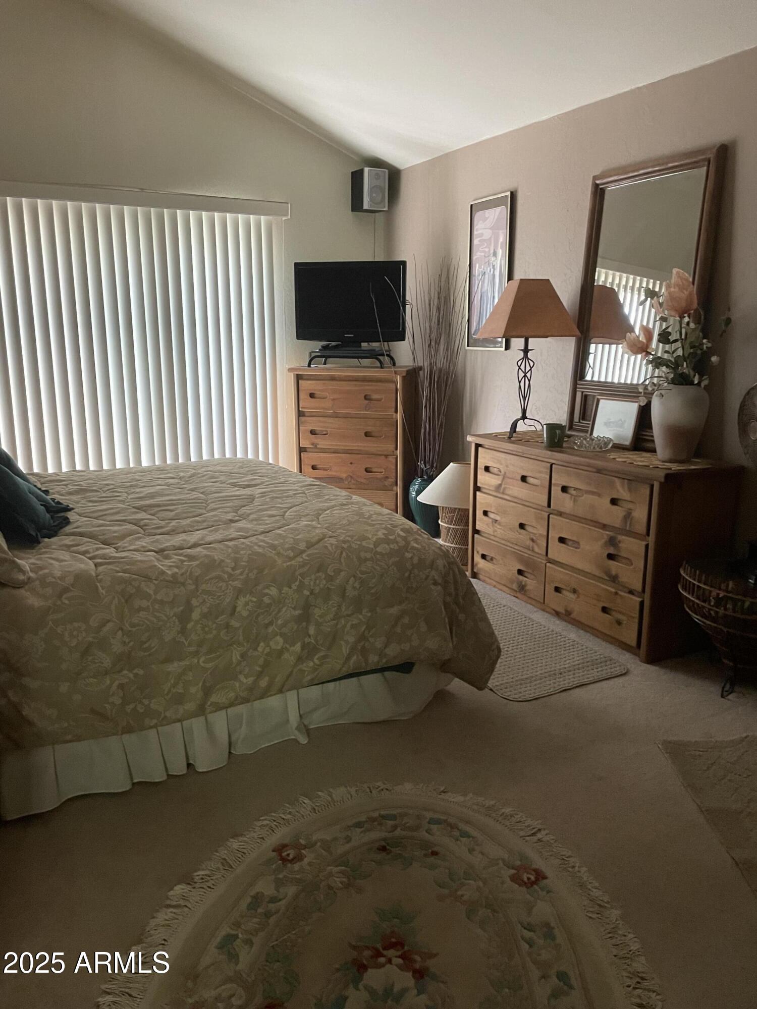 4479 Resort Loop, Unit A21 Pinetop, AZ 85935 - Photo 11 of 12 a bedroom with a bed and dresser with mirror