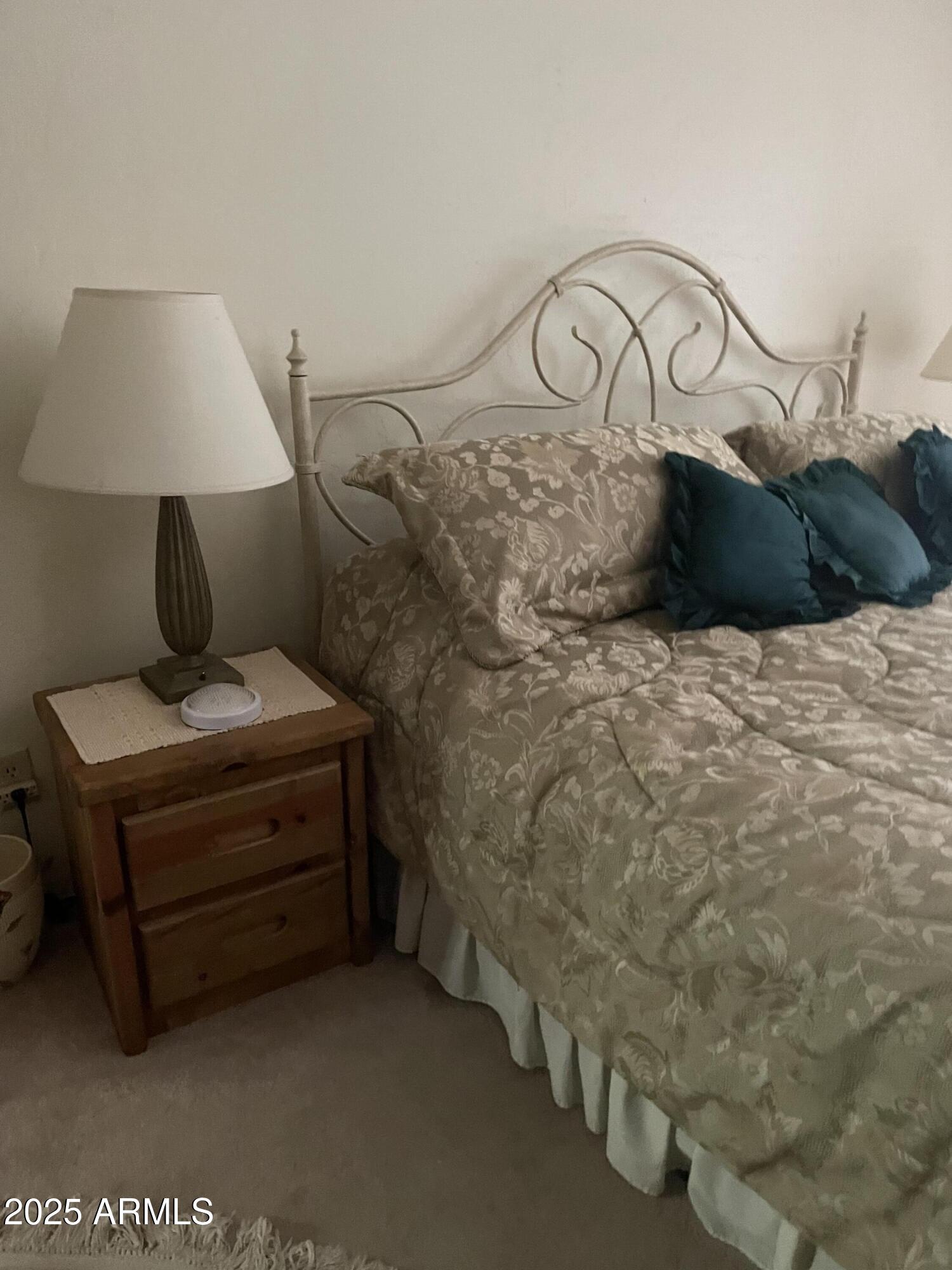 4479 Resort Loop, Unit A21 Pinetop, AZ 85935 - Photo 12 of 12 a bed sitting in a room next to a lamp