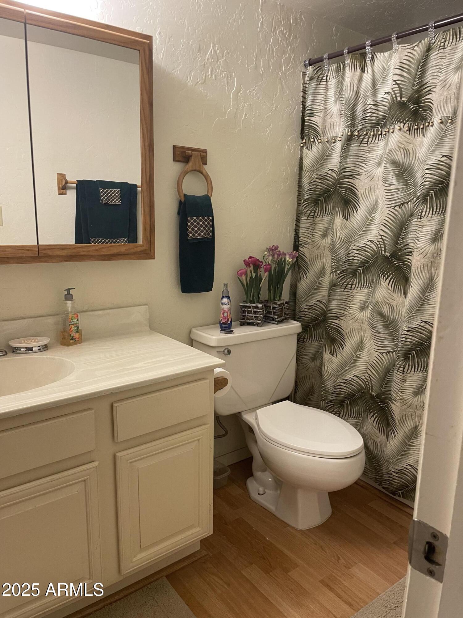 4479 Resort Loop, Unit A21 Pinetop, AZ 85935 - Photo 10 of 12 a bathroom with a toilet sink and mirror
