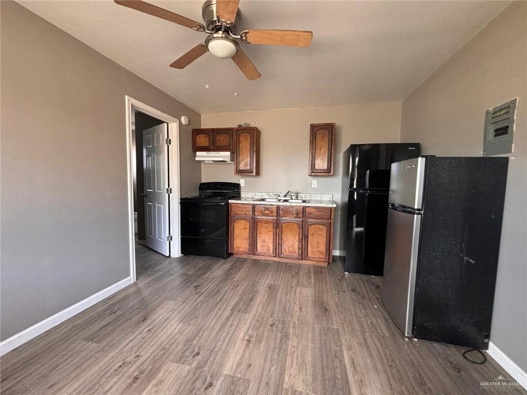102 South Holland Avenue, Unit AR Mission, TX 78572 - Photo 2 of 5 a kitchen with stainless steel appliances granite countertop a refrigerator and a sink