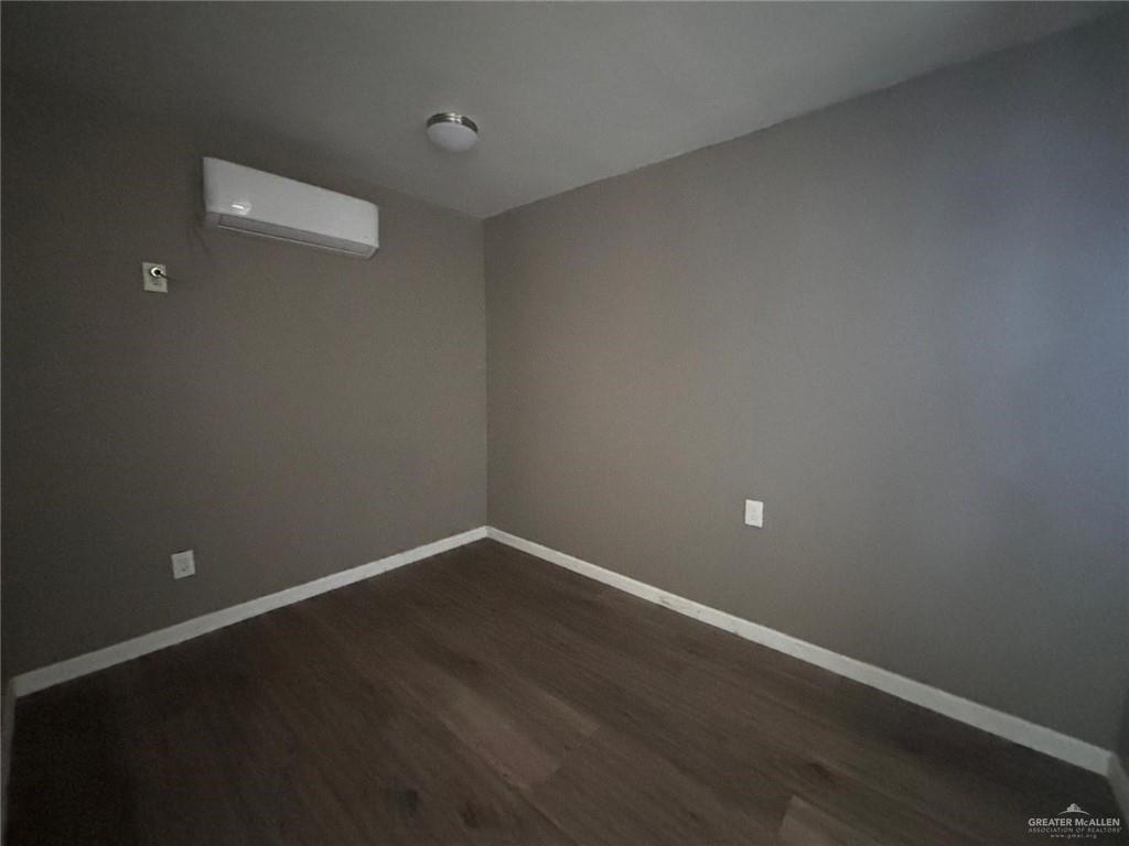 102 South Holland Avenue, Unit AR Mission, TX 78572 - Photo 4 of 5 a view of an empty room with wooden floor