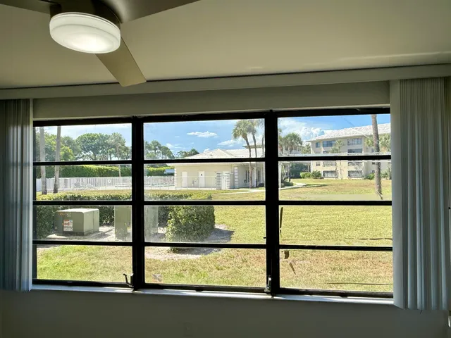 an empty room with an entryway and fan