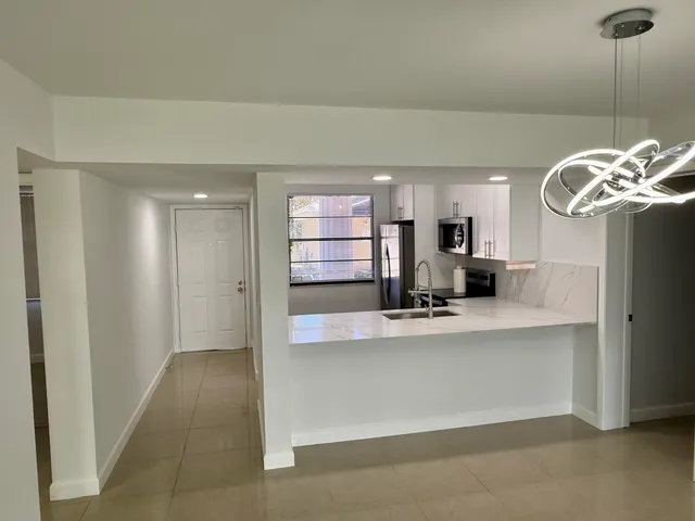 a kitchen with stainless steel appliances a stove sink and microwave