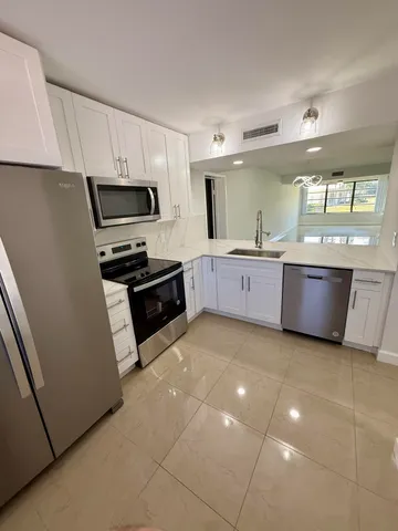 a large kitchen with a cabinets and a sink