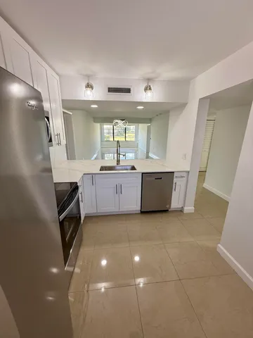 a kitchen with a sink a stove and microwave