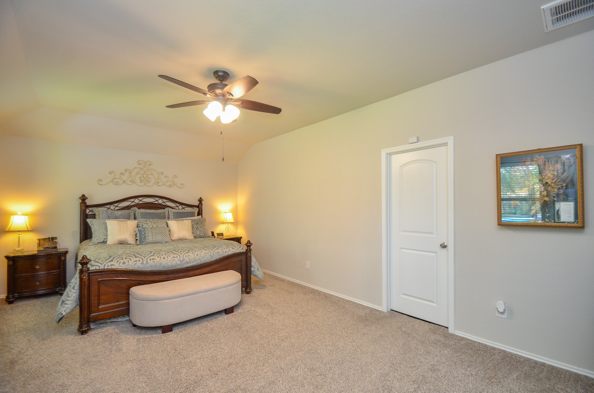 3810 Willow Valley Conroe, TX 77301 - Photo 22 of 38 a bedroom with a bed and a chandelier