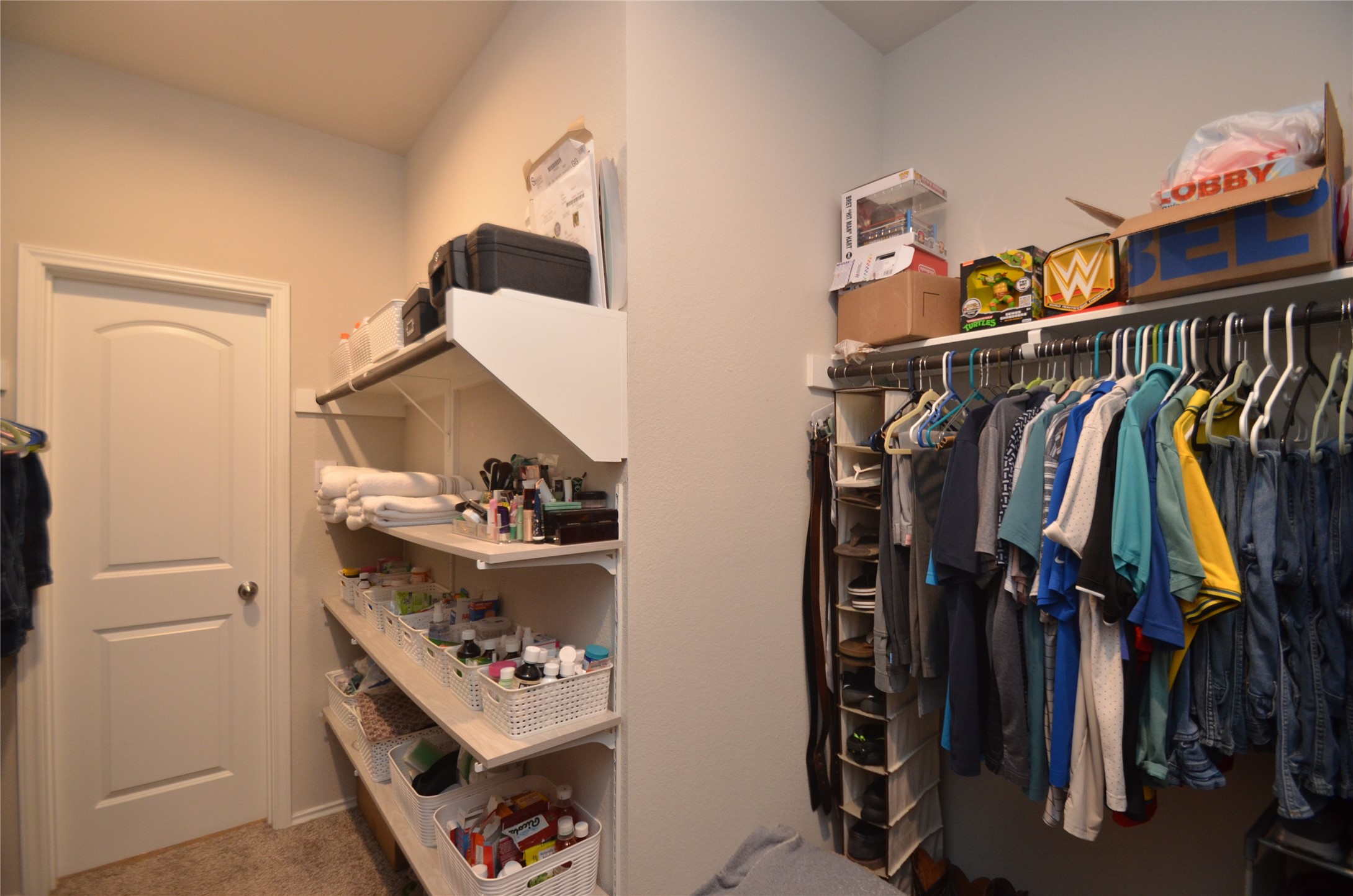 3810 Willow Valley Conroe, TX 77301 - Photo 24 of 38 a view of walk in closet with clothes and shoes