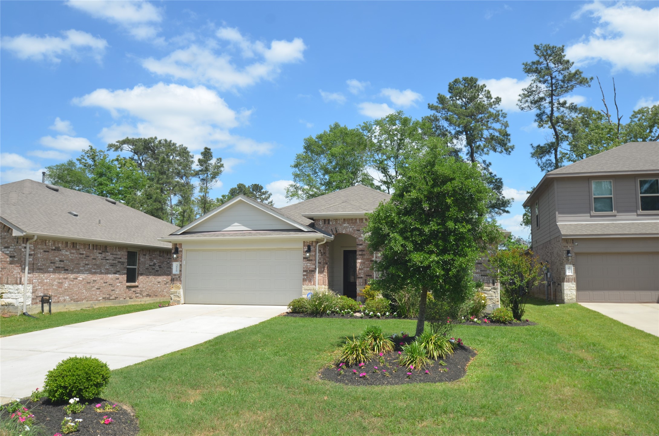 3810 Willow Valley Conroe, TX 77301 - Photo 38 of 38 a front view of a house with a garden and plants