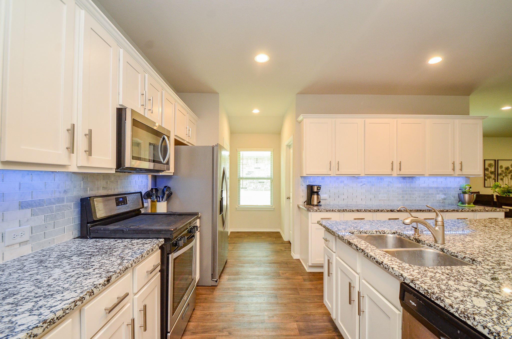 3810 Willow Valley Conroe, TX 77301 - Photo 9 of 38 a kitchen with a sink stove and cabinets