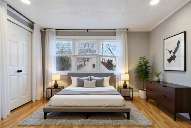 a bedroom with a large bed and a window