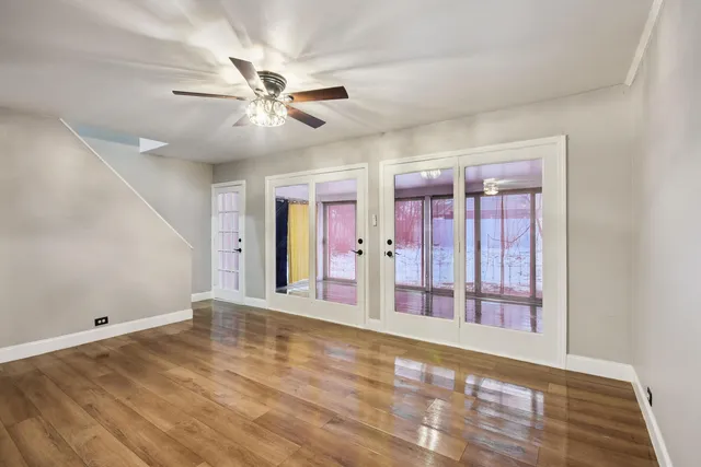 wooden floor in an empty room with a window