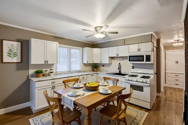 a kitchen with a table chairs and microwave