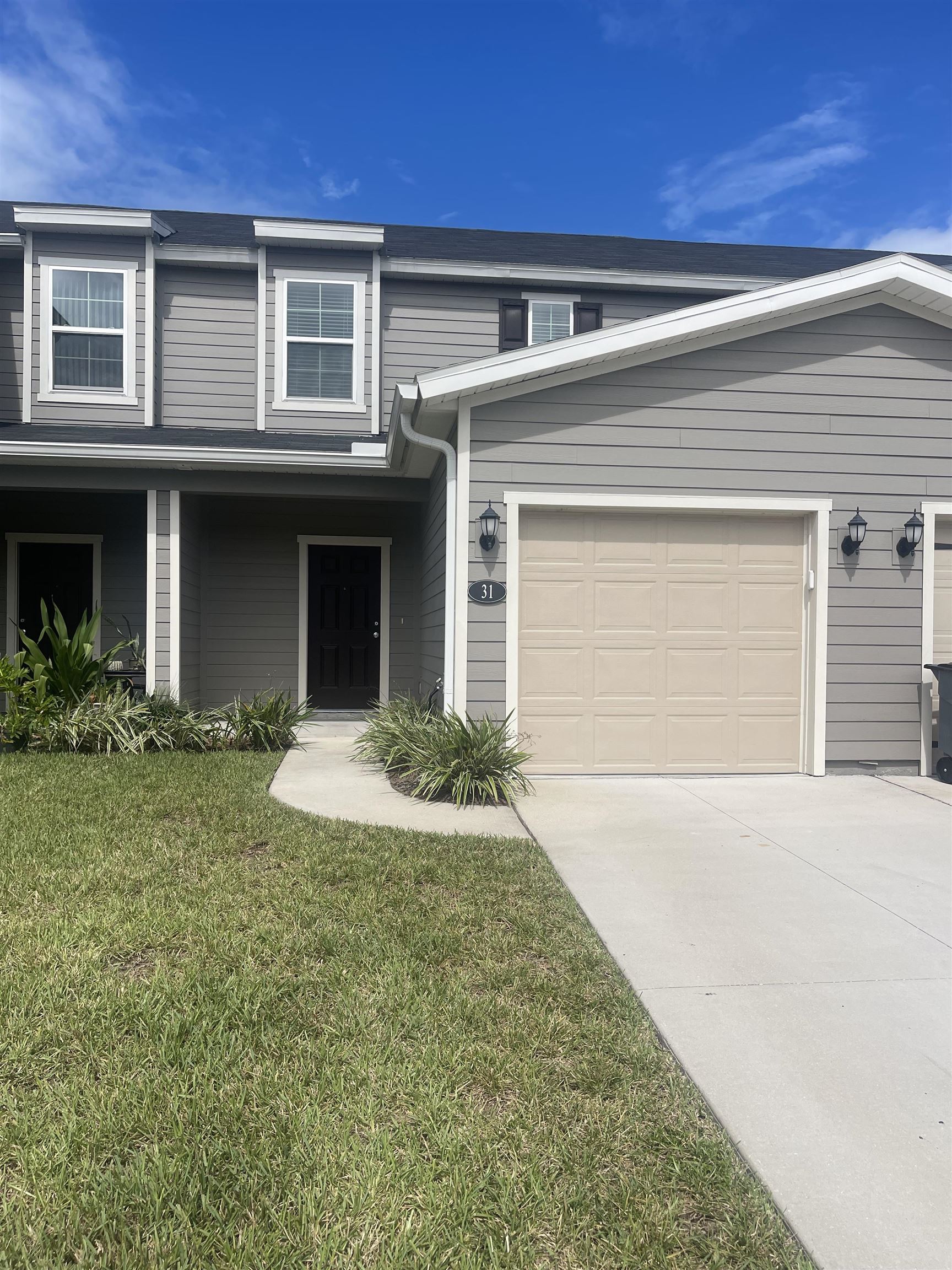 31 Great Star Court St. Augustine, FL 32086 - Photo 2 of 17 a front view of a house with a yard and garage