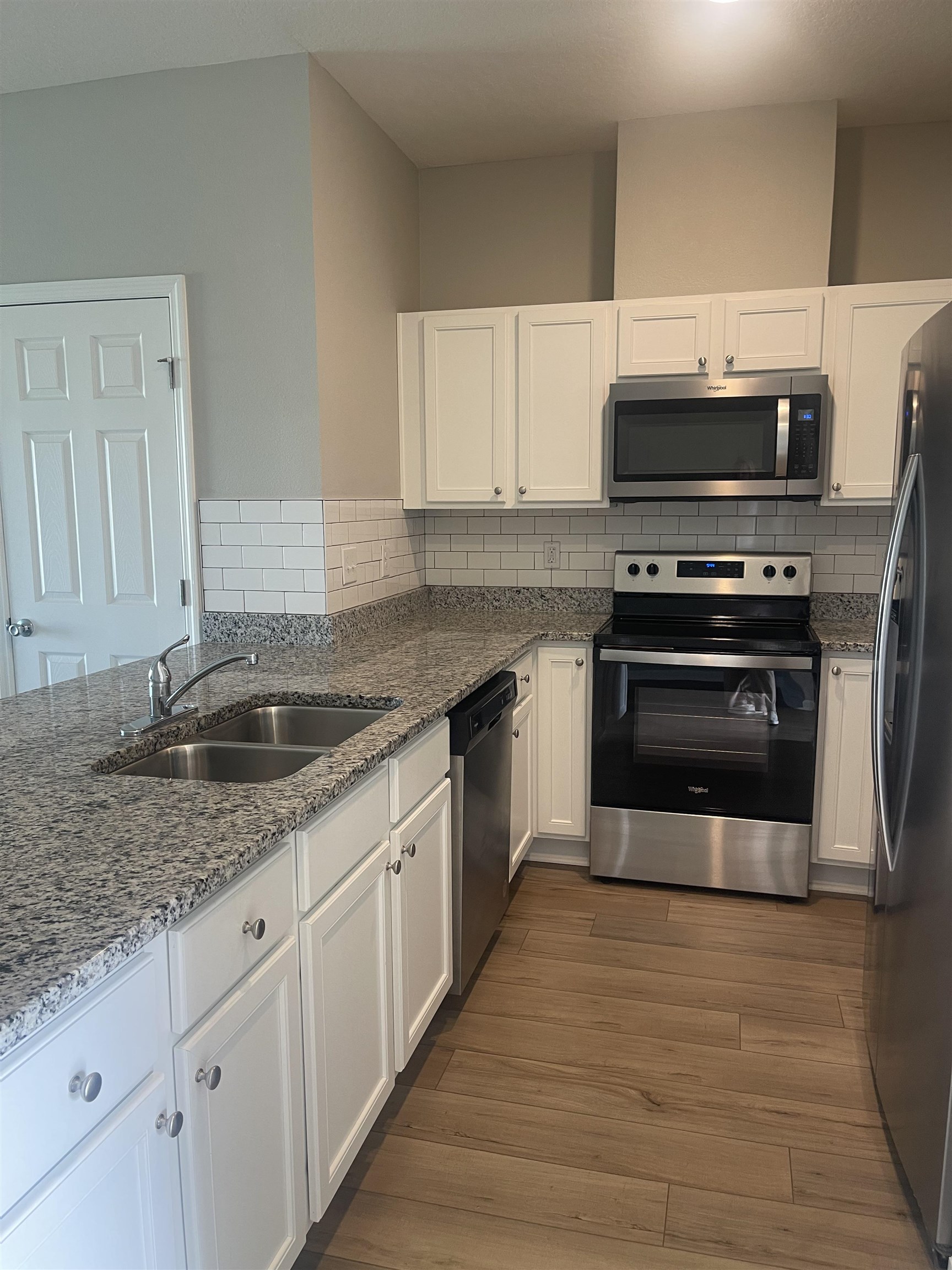 31 Great Star Court St. Augustine, FL 32086 - Photo 3 of 17 a kitchen with stainless steel appliances granite countertop a stove a sink and a microwave
