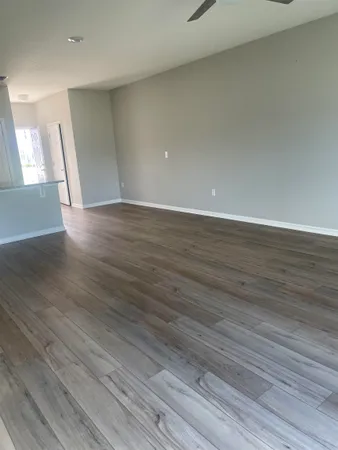a view of an empty room and wooden floor