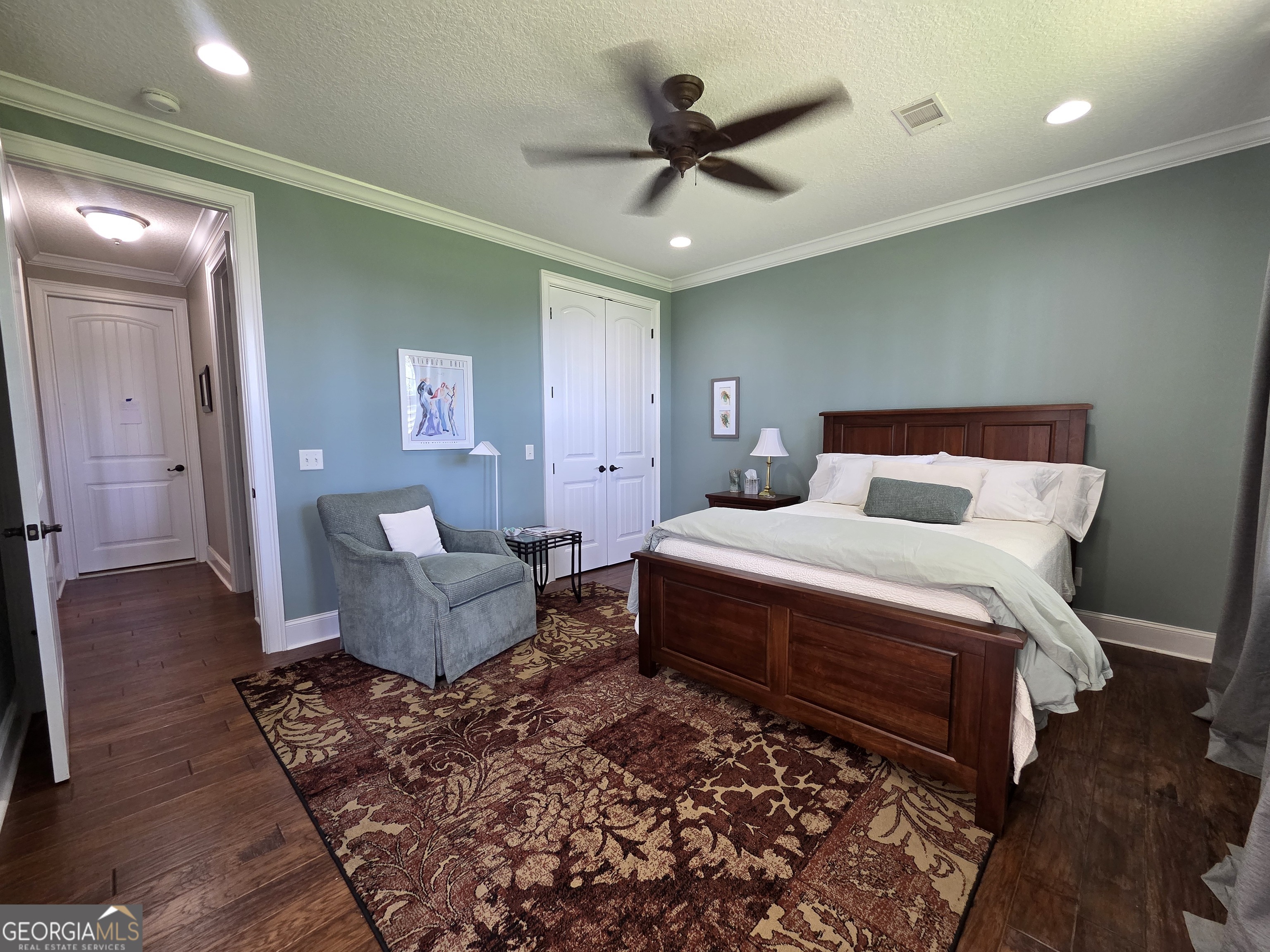 300 Hammond Powell Road Hazlehurst, GA 31539 - Photo 85 of 91 a bedroom with a large bed and a chandelier
