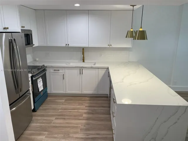 a kitchen with a sink and cabinets
