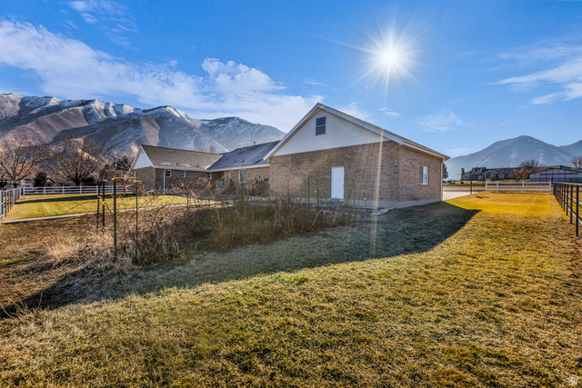 1060 West 2620th Street South Mapleton, UT 84664 - Photo 57 of 87 View of home's exterior with a mountain view and a fenced backyard