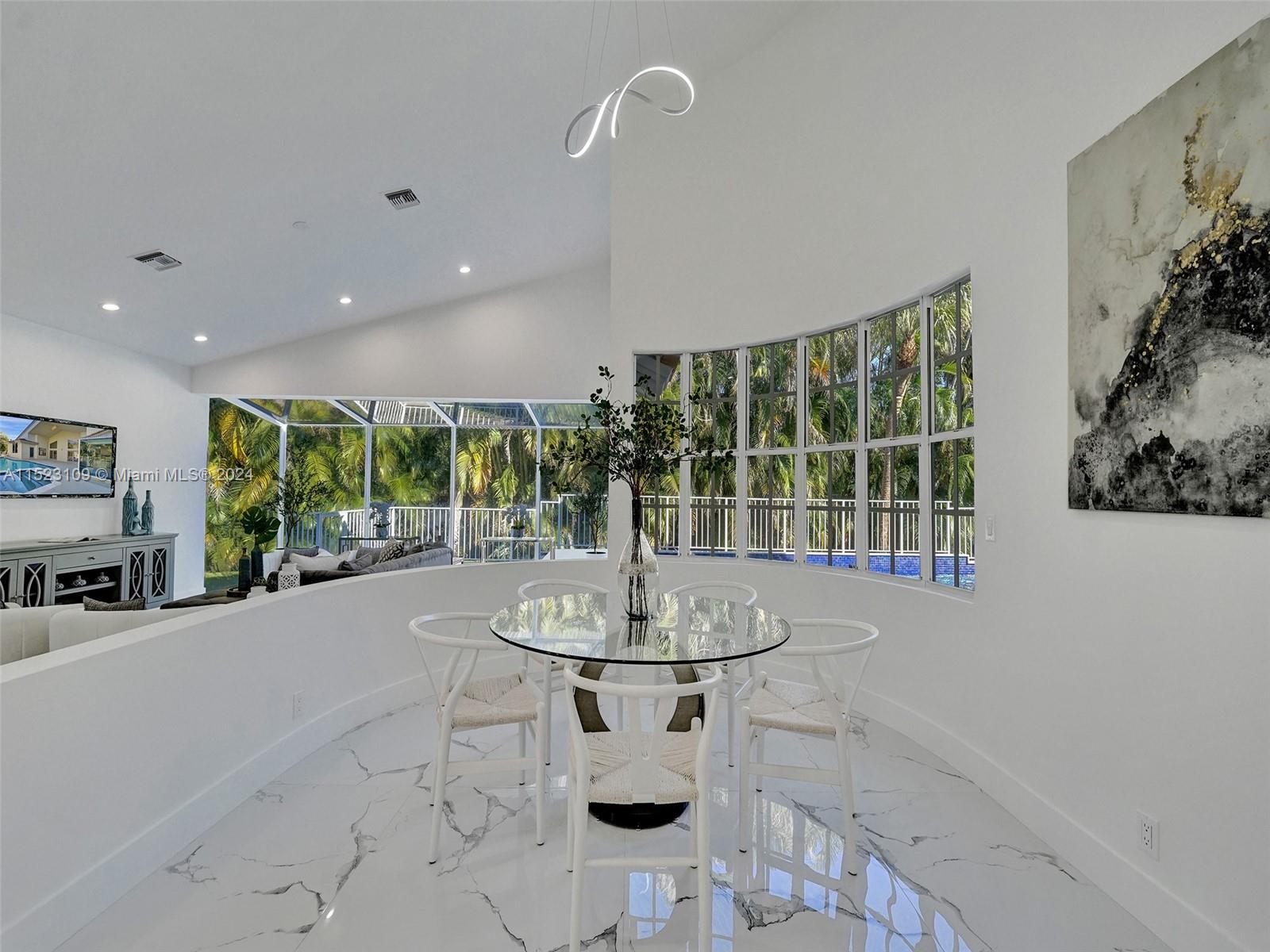 791 Parkside Circle North Boca Raton, FL 33486 - Photo 16 of 87 a dining room with furniture and a floor to ceiling window