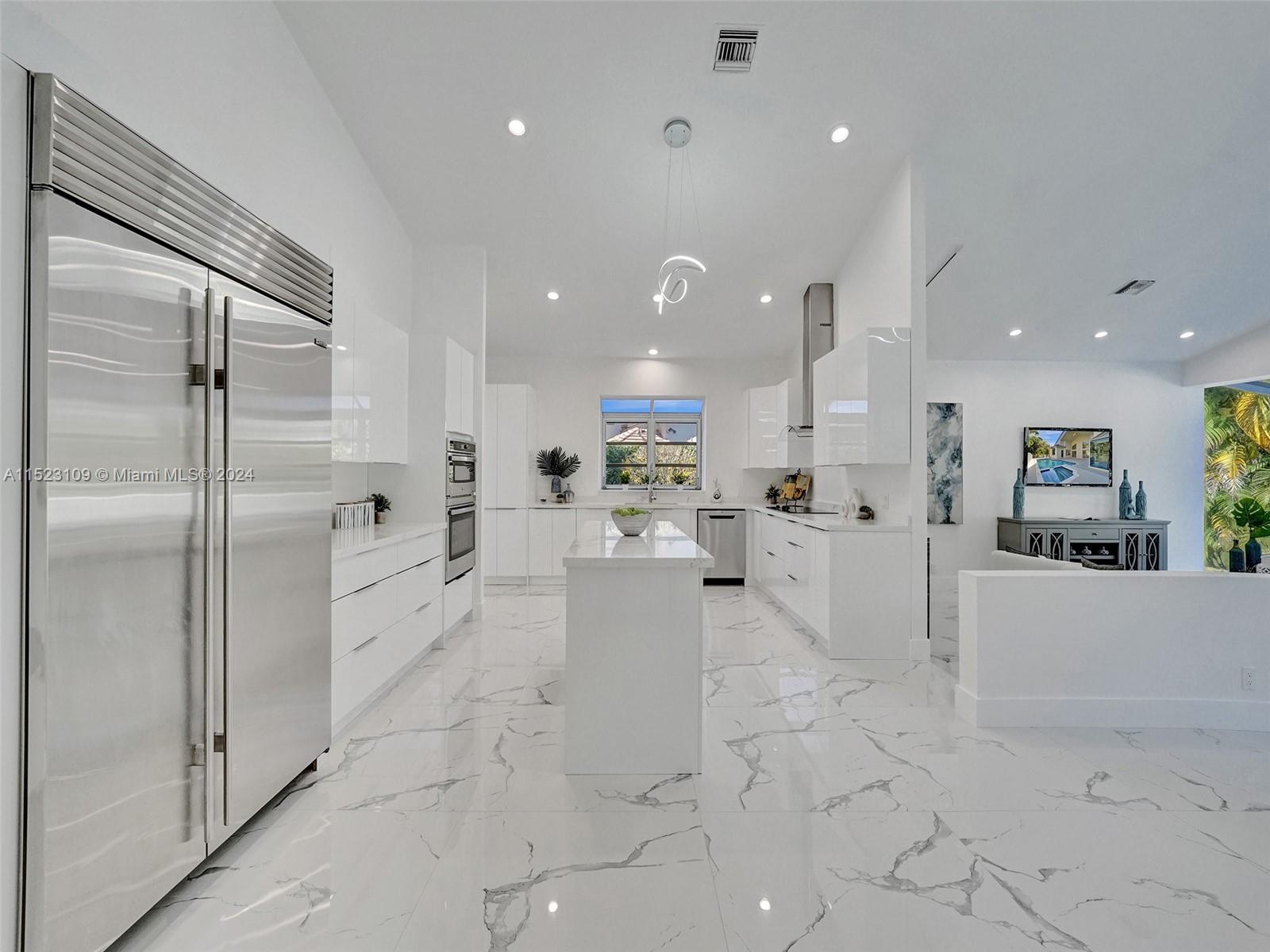 791 Parkside Circle North Boca Raton, FL 33486 - Photo 20 of 87 a view of a kitchen with kitchen island a counter top space appliances and cabinets