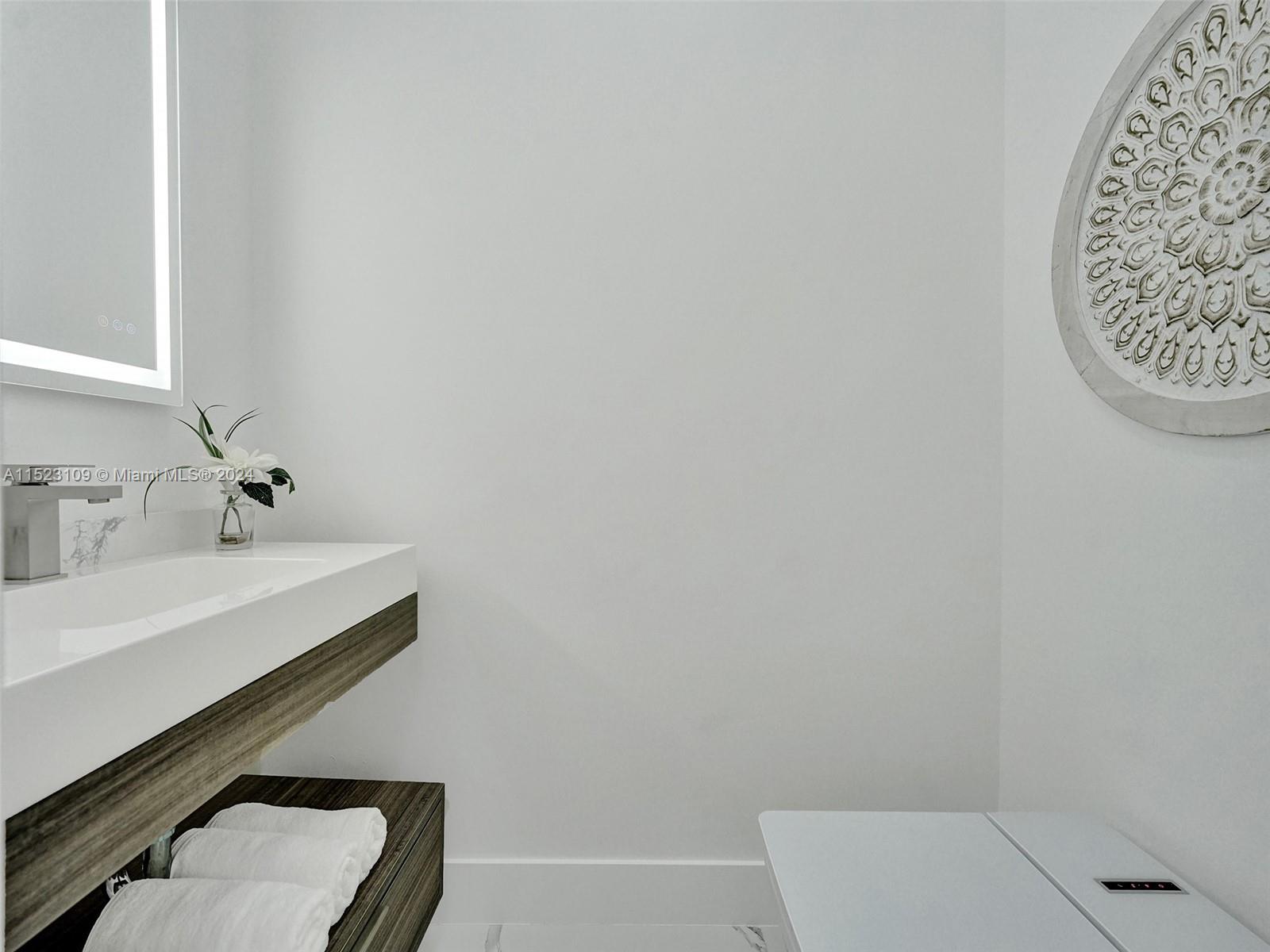 791 Parkside Circle North Boca Raton, FL 33486 - Photo 46 of 87 a bathroom with a sink a toilet and mirror
