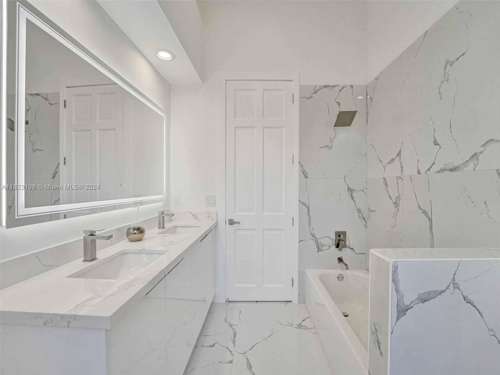 791 Parkside Circle North Boca Raton, FL 33486 - Photo 47 of 87 a bathroom with a double vanity sink a mirror and a bathtub
