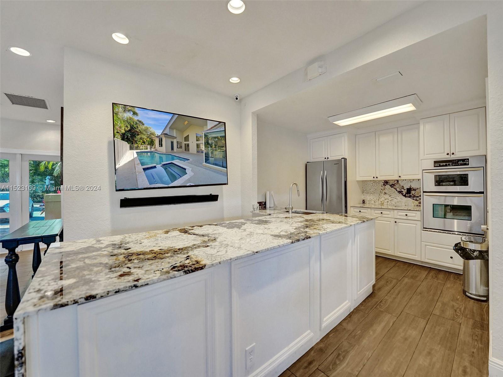 791 Parkside Circle North Boca Raton, FL 33486 - Photo 78 of 87 a room with stainless steel appliances kitchen island granite countertop a sink and cabinets