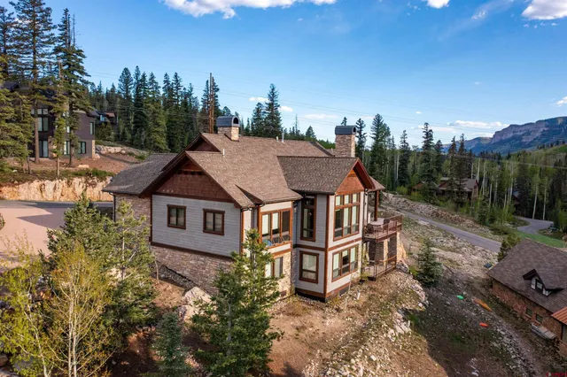 an aerial view of a house with a yard and balcony