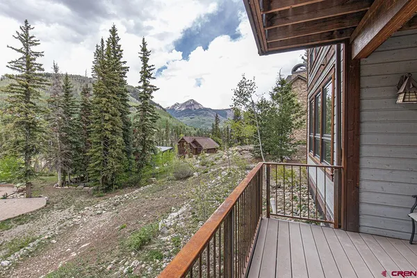 a view of balcony with wooden floor and fence