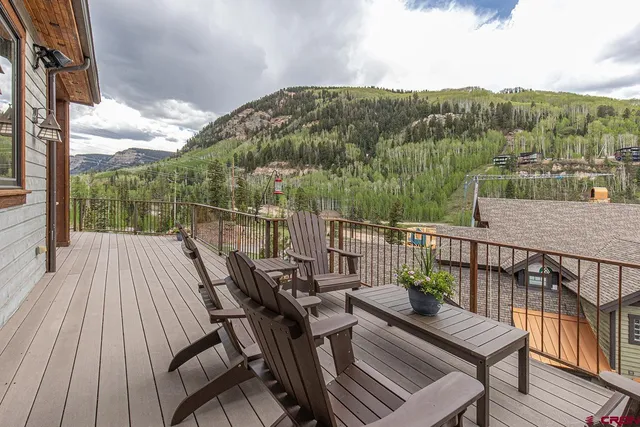 a view of a balcony with a table and chairs