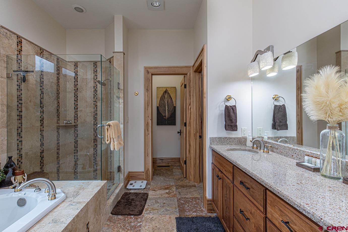 59 Snowden Drive Durango, CO 81301 - Photo 17 of 45 a bathroom with a granite countertop double vanity sink mirror and shower