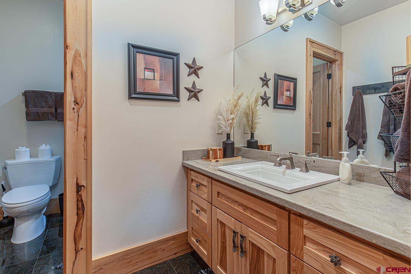59 Snowden Drive Durango, CO 81301 - Photo 26 of 45 a bathroom with a granite countertop sink mirror and toilet