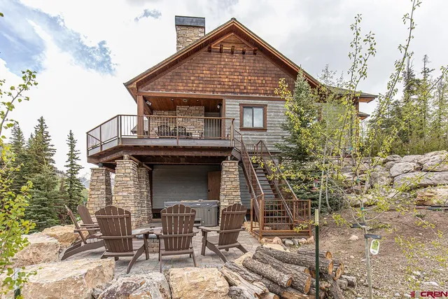 a view of a patio with lawn chairs fire pit and outdoor seating