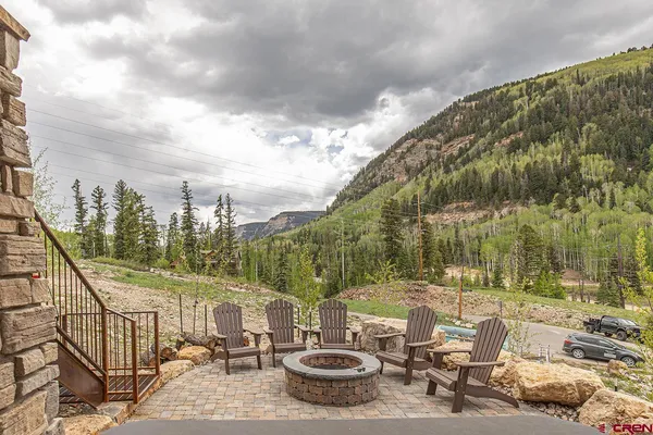 a view of a swimming pool with a patio and couches