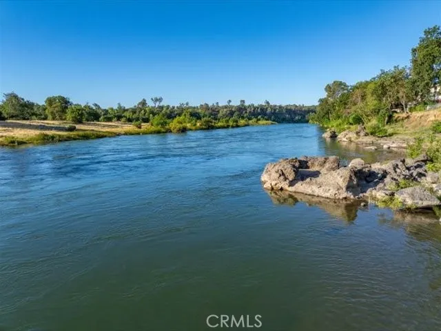 a view of a lake with houses in back