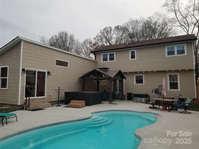 a front view of house with yard outdoor seating and barbeque oven