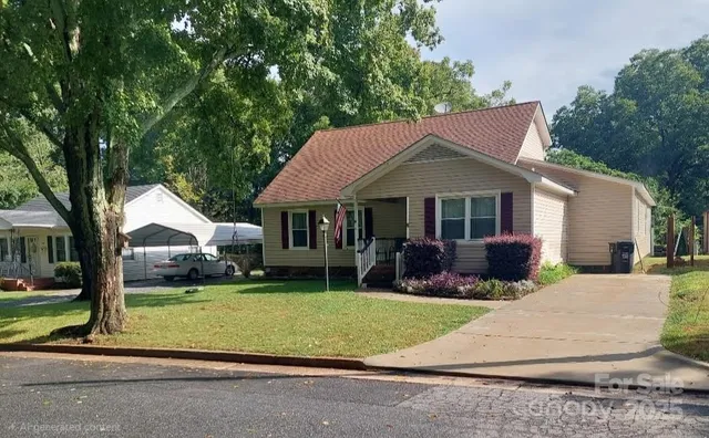 a front view of a house with a yard garden and outdoor seating