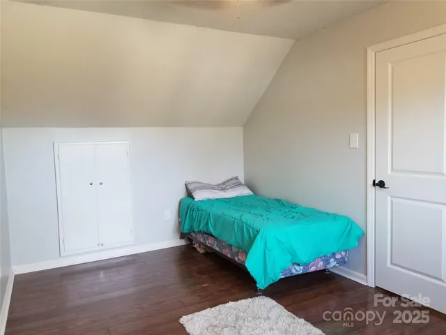 a bed sitting in a bedroom next to a window