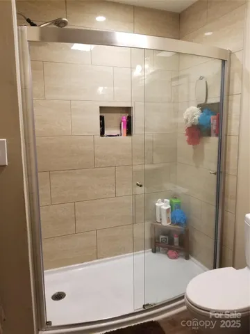 a bathroom with a shower and toilet