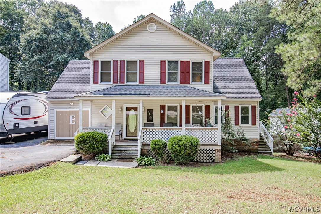 12137 Quito Road Midlothian, VA 23112 - Photo 1 of 34 a front view of a house with a garden and plants